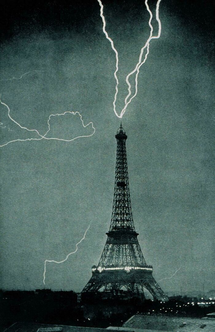Historic site photo of the Eiffel Tower struck by lightning during a storm, highlighting dramatic historic moments.