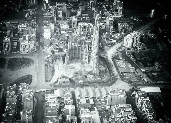 Aerial black and white photo of historic site surrounded by city buildings showcasing architectural history perspective.