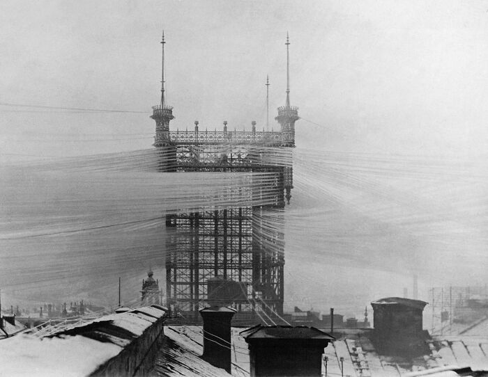 Historic site showing early 20th-century tower construction with network of wires illustrating technological advancements.
