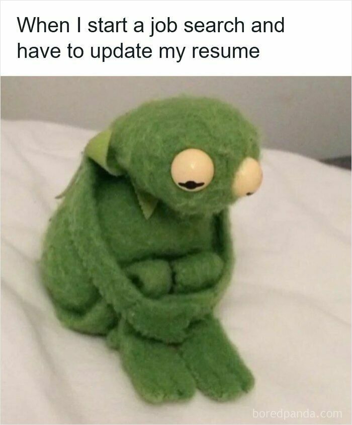 Sad green puppet sitting on a bed, representing frustration with updating a resume during a job search.
