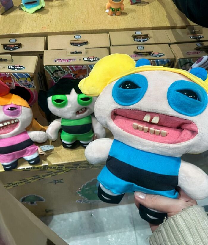Plush toys resembling cartoon characters with distorted, funny faces in a display, capturing confusing pictures that are funny.