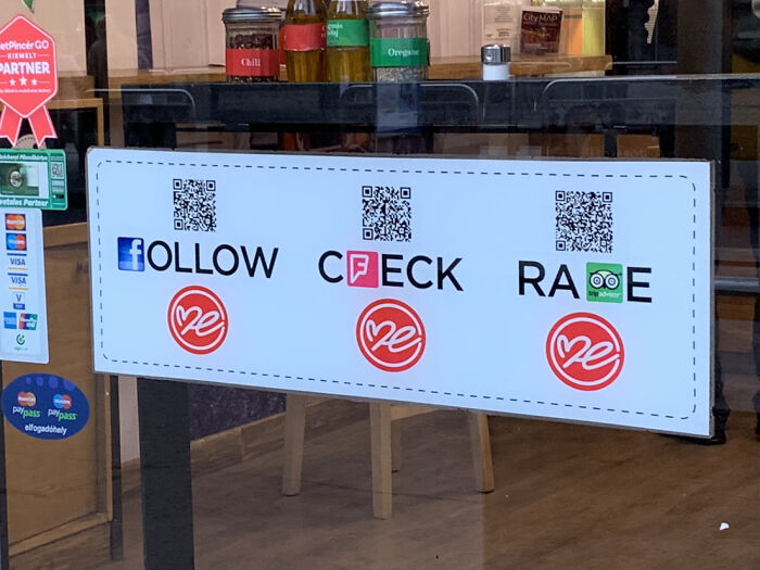 Sign with misspelled words follow, ceck, and rate displayed on a restaurant window showing design fails.