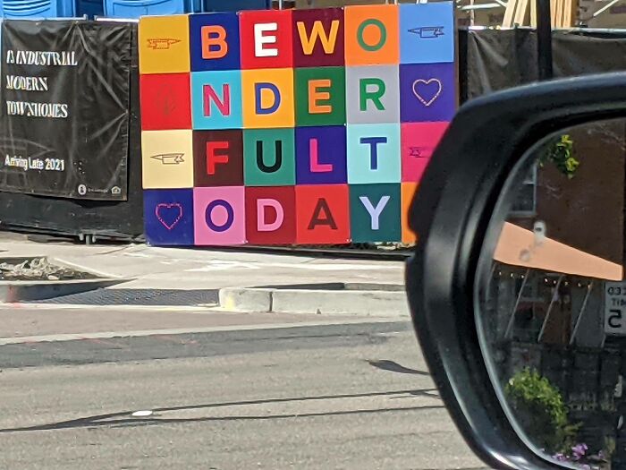 Colorful sign with mixed letters spelling confusing words, showcasing designers' attempts that failed writing clearly outside on the street.