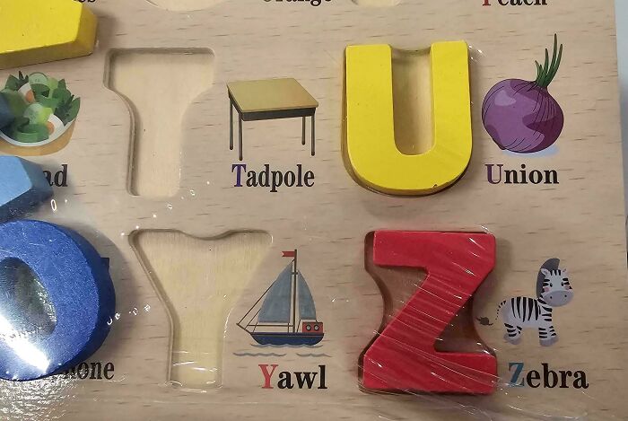Wooden alphabet puzzle showing misspelled words like Yawl and Union illustrating design fails and writing mistakes by designers.