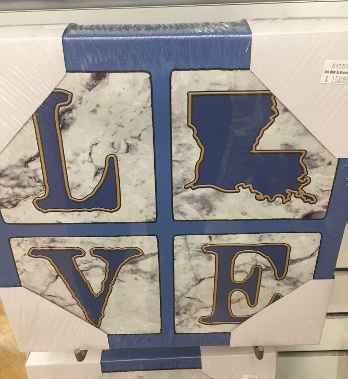 Home decor sign showing the word love with the letter O replaced by a state shape, a common designers writing fail example.