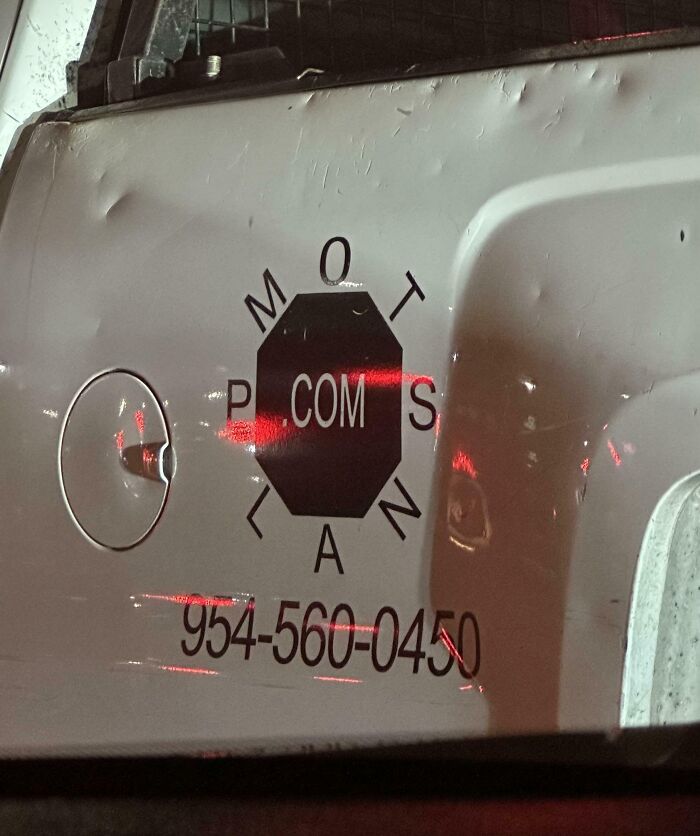 White vehicle side with a poorly designed logo where the word "COMPASS" is jumbled, showcasing designer writing fails.