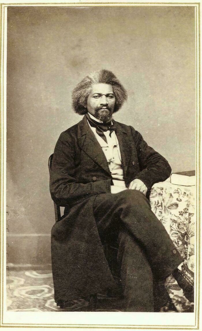 Portrait of Frederick Douglass seated indoors, a powerful figure in US history photos that reveal the past uniquely.