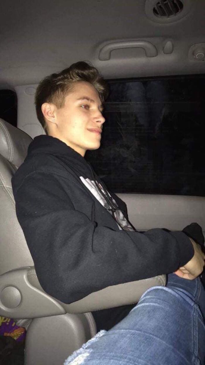 A young man sitting in a car seat at night, reflecting on the story of a dad hearing his late son&rsquo;s heartbeat.
