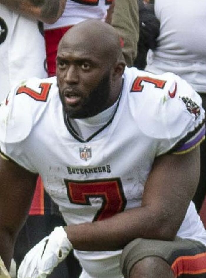 Leonard Fournette in Tampa Bay Buccaneers uniform during a football game, focused and ready to play.