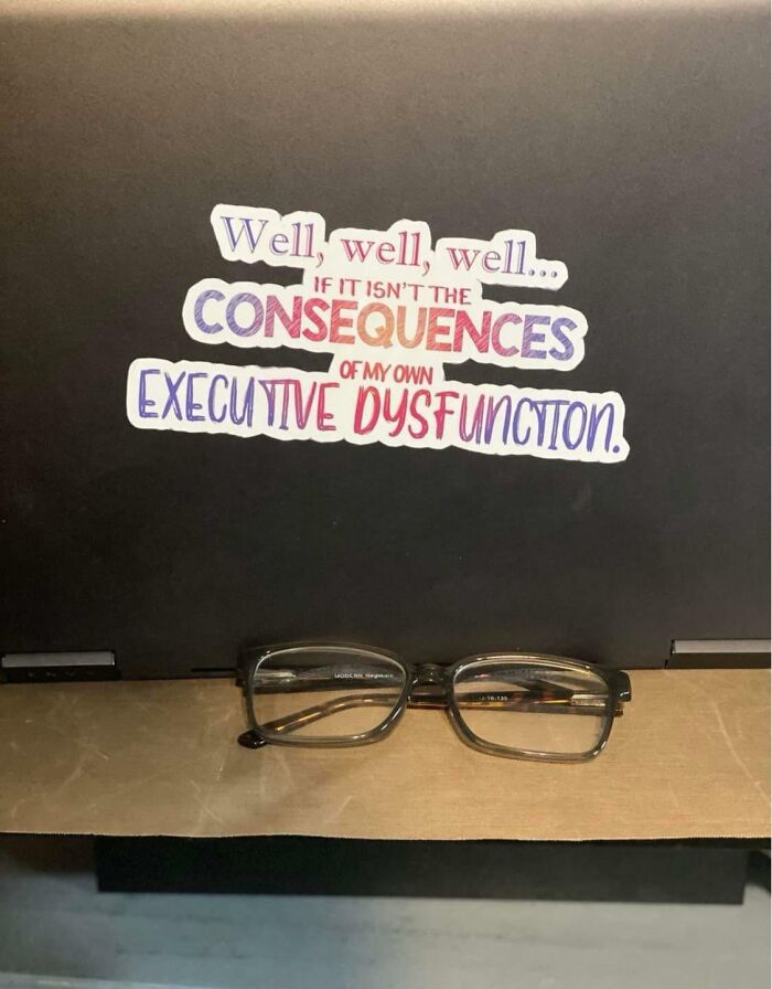 Sticker on a laptop with a quote about executive dysfunction, representing life with a spicy neurodivergent brain.