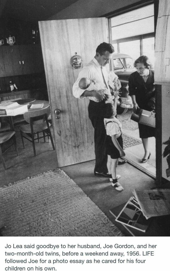 Father caring for four children at home in 1956, showcasing a historical photograph from a world you'd hardly recognize today.