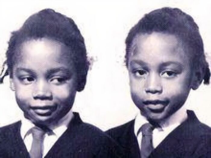 Black and white photo of two young children in school uniforms, relating to unsettling history and crime stories.
