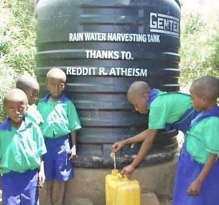 Children in uniform collecting water from a rainwater harvesting tank, illustrating real dystopia moments in daily life.