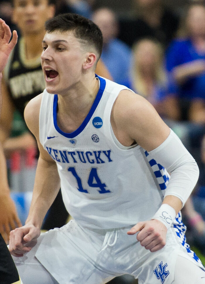 Tyler Herro playing basketball for Kentucky Wildcats, showing intensity during a college basketball game.