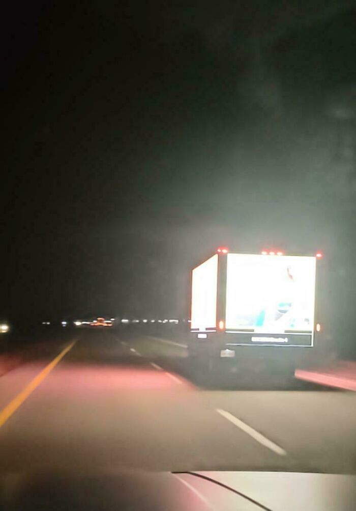 Brightly lit truck driving on a dark highway at night, illustrating unsettling images that make the U.S. look like a warning.