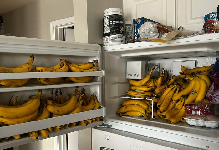 Open fridge packed with numerous bananas, showcasing one of the most interesting fridge contents not matching Pinterest aesthetic vibes.