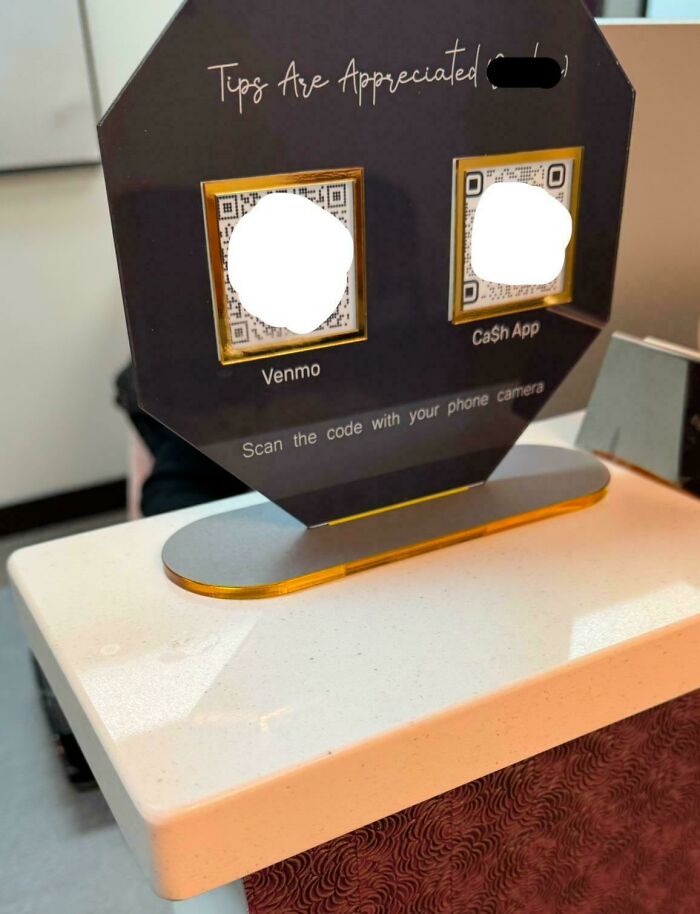 Contactless tip payment sign using Venmo and Cash App QR codes on a table in a U.S. setting reflecting modern payment trends.