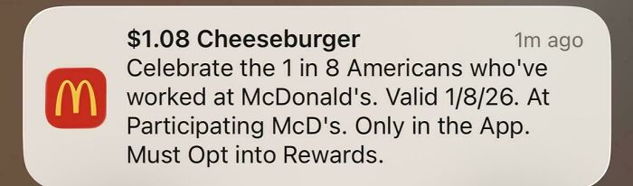 Notification from McDonald's app offering a $1.08 cheeseburger deal, reflecting unusual pricing trends in the U.S. market.