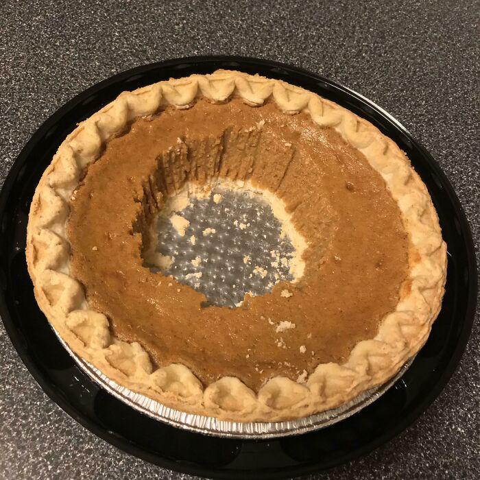 Partially eaten pumpkin pie with a large bite missing from the center, illustrating roommate jerk behavior.