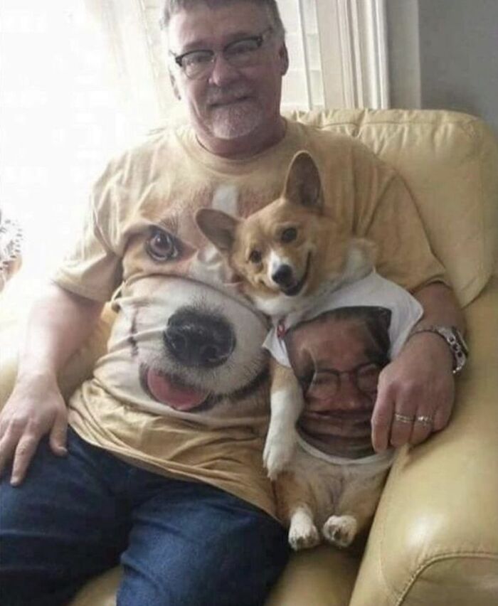 Man sitting on couch with a dog wearing matching funny and cute dog photos t-shirts, both smiling at the camera.