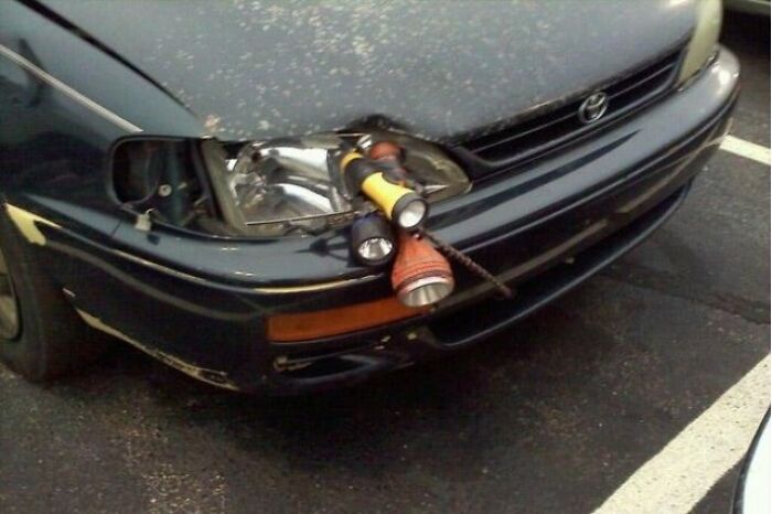 Car headlight broken and poorly fixed with flashlights and tape, an epic DIY fail needing shaming.
