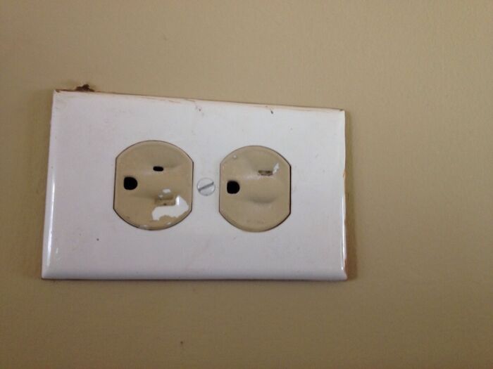Damaged and improperly installed electrical outlet showing a clear example of a DIY fail needing repair.
