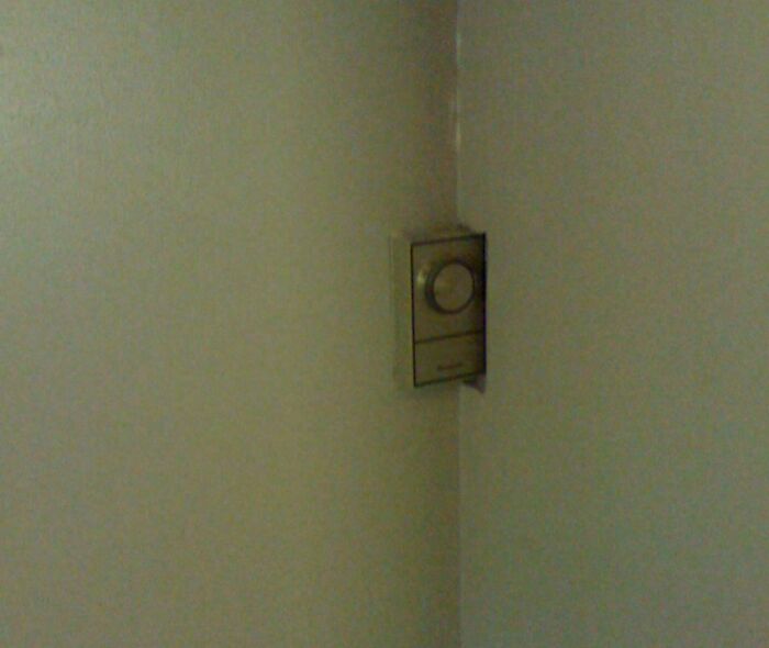 Doorbell installed awkwardly in a tight corner, showcasing a clear DIY fail and poor placement in the home.