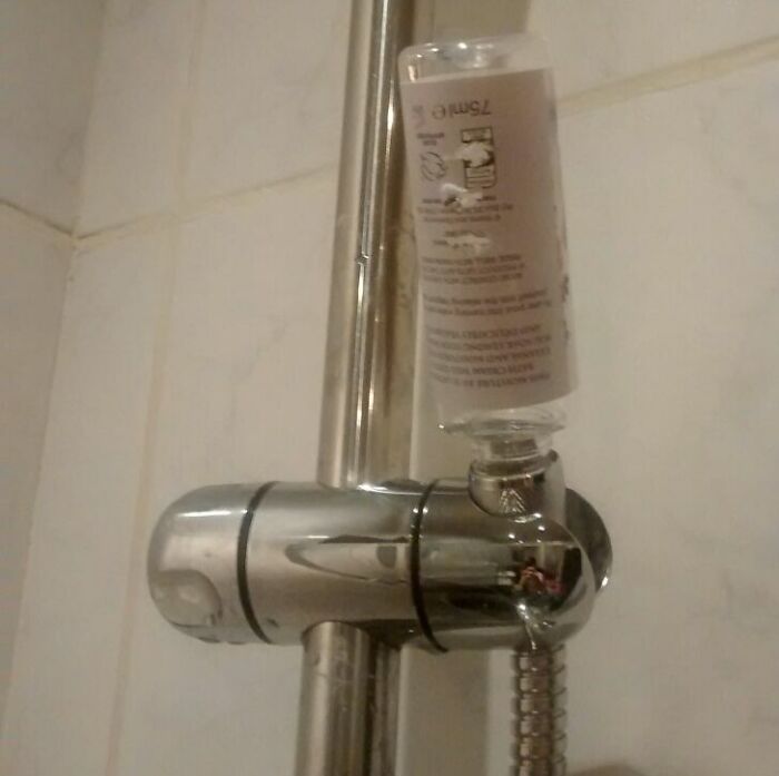 DIY fail showing a shower fixture improperly installed with a bottle awkwardly attached to the shower handle.