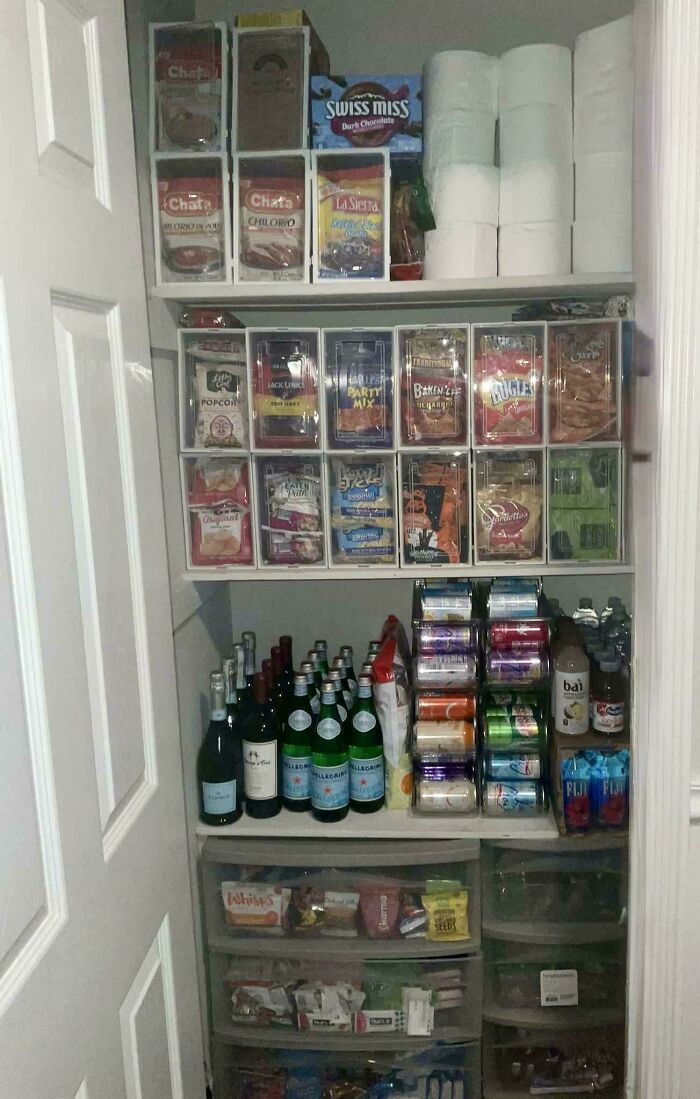 Neatly organized pantry with snacks, drinks, and paper towels arranged efficiently to bring order into your life.
