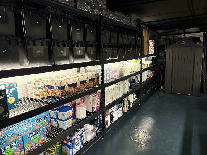 Neatly organized storage shelves with labeled bins and food items arranged to bring order into a pantry space.