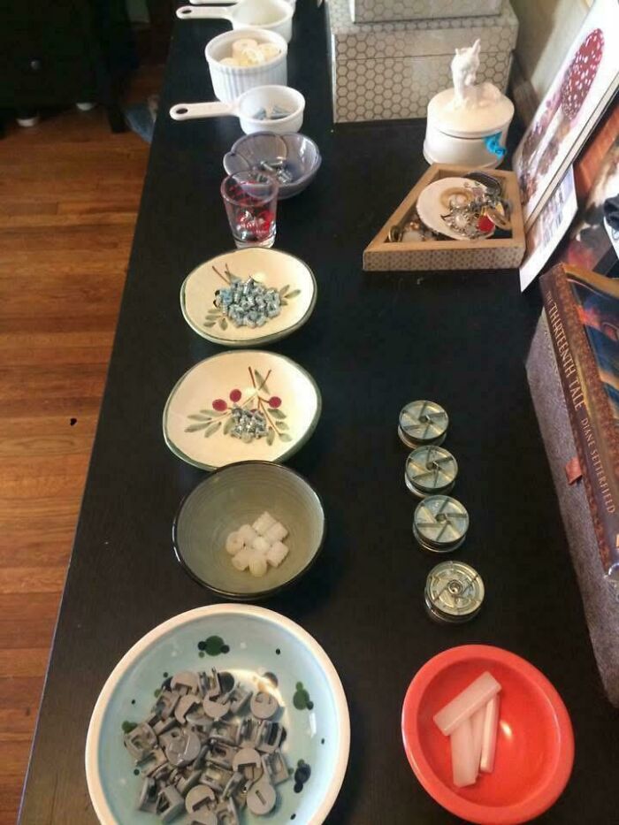 Neatly organized bowls and containers on a table holding various small household items for order and tidiness.