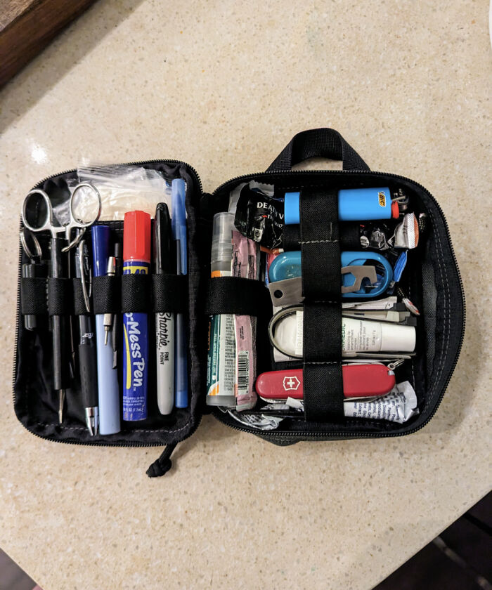 Neatly organized compact pouch filled with various tools and writing instruments to bring order into your life.