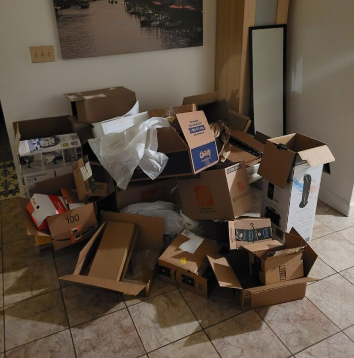 Messy room filled with scattered cardboard boxes and clutter, showing a typical jerk roommate's untidy living space.