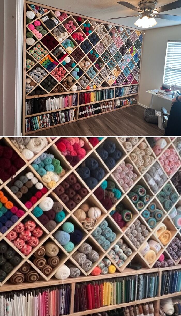 Neatly organized yarn and fabric stored in a creative wooden shelf system for crafting and sewing supplies.