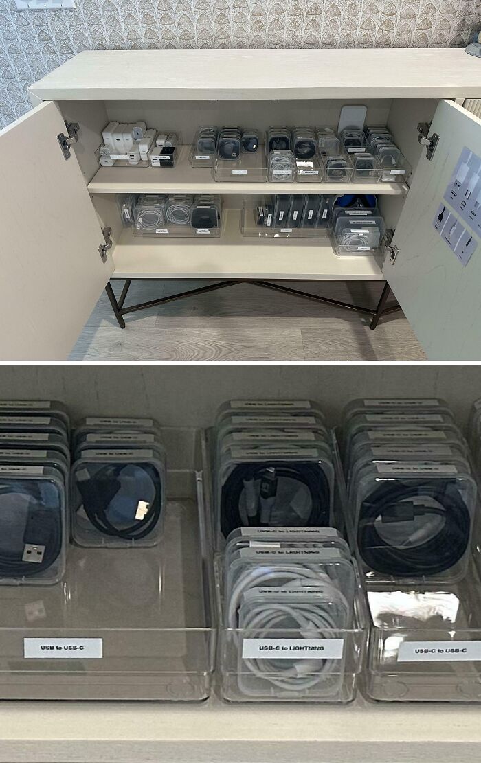 Neatly organized charging cables and adapters sorted in clear containers inside a cabinet for an orderly space.