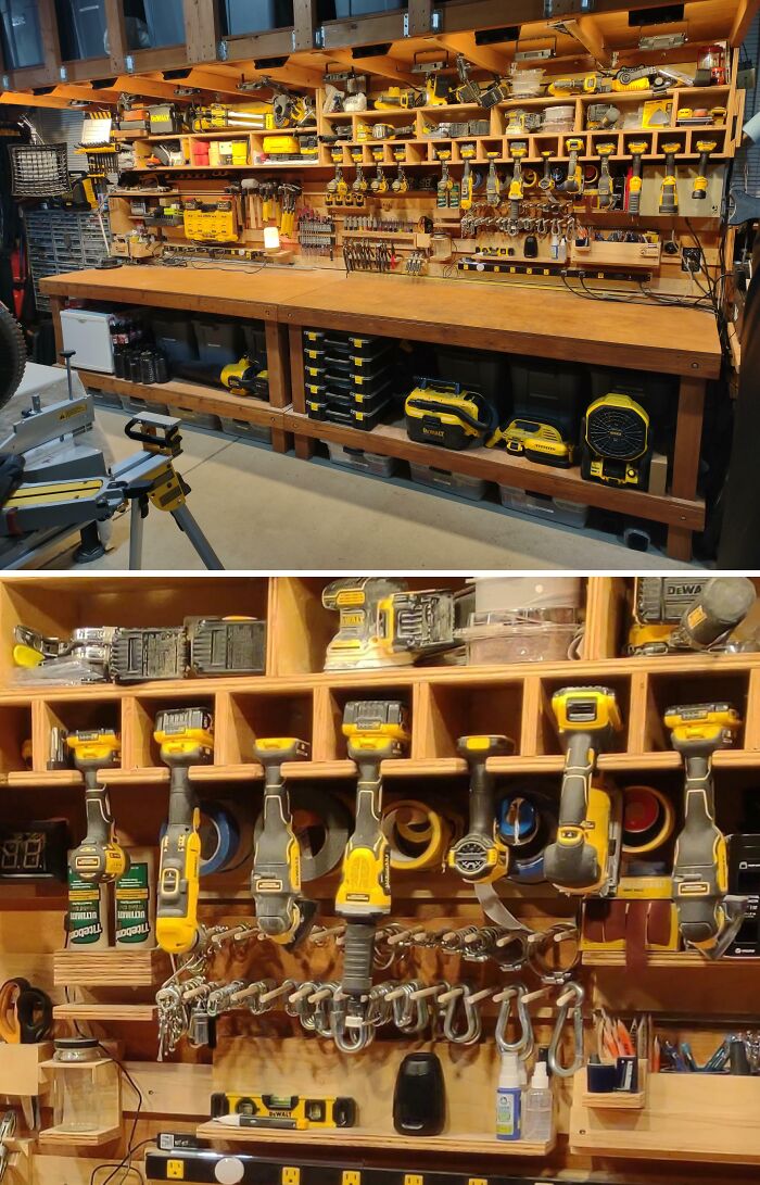 Neatly organized workshop with yellow power tools and hand tools hanging on wooden shelves and pegboards.