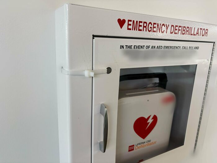 Emergency defibrillator in a workplace setting highlighting the importance of safety measures and reckless work moments awareness.