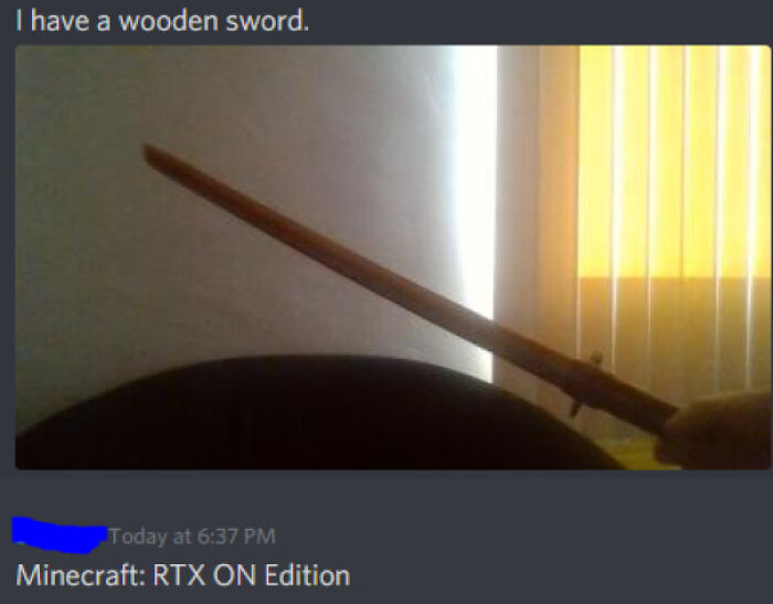 Image of a wooden sword held up indoors with a humorous social media comeback about Minecraft RTX ON edition.