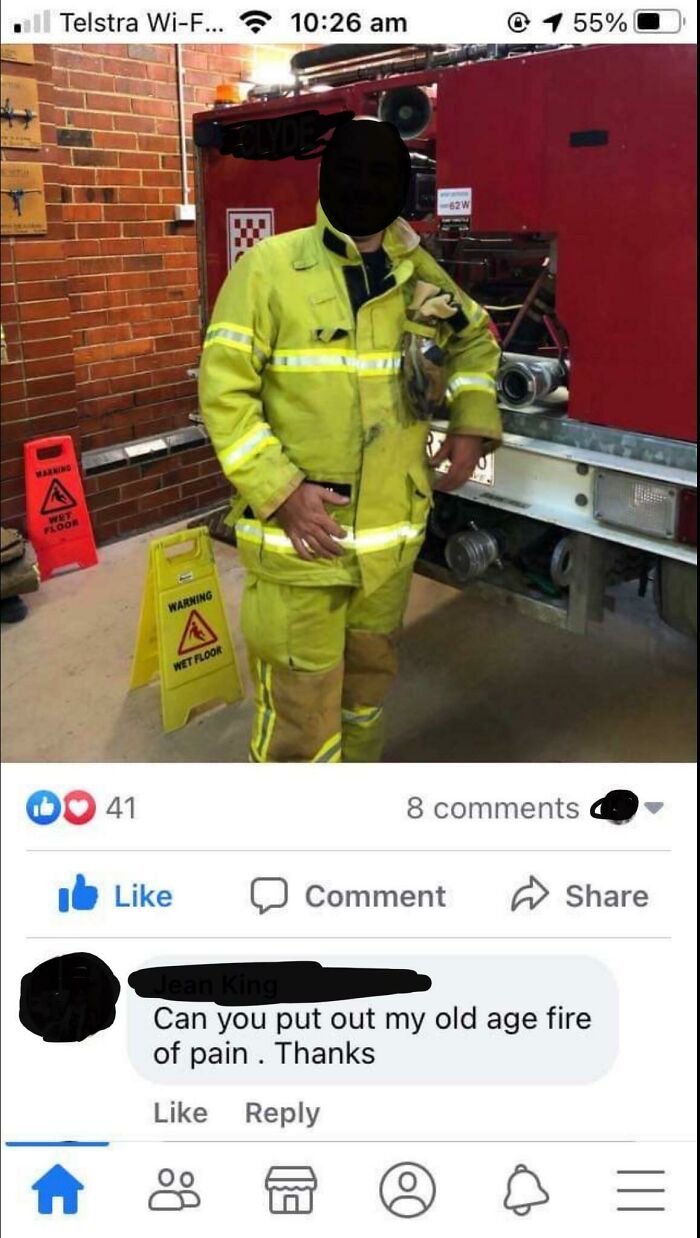Firefighter in uniform posing by fire truck with a humorous social media comeback comment below.