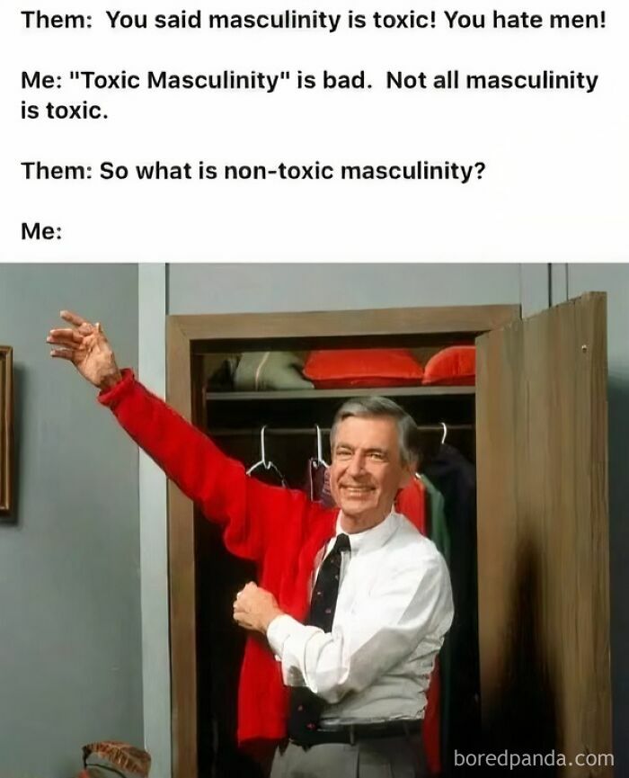 Man smiling while putting on a red sweater, illustrating a post calling out the world we're living in about toxic masculinity.