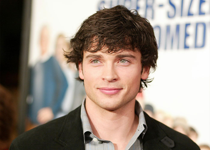 2000s teen heartthrob with tousled dark hair and green eyes posing at a movie premiere event. 2000s teen heartthrob with tousled dark hair and green eyes posing at a movie premiere event.