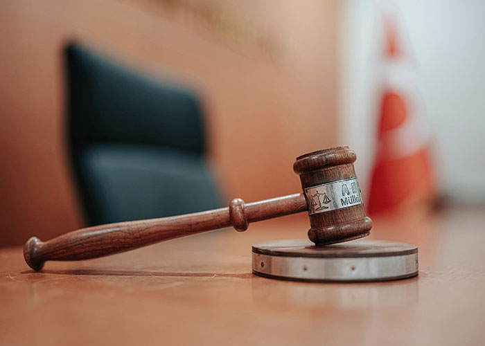Wooden judge gavel on desk in courtroom symbolizing legal issues of father changing gender identity to avoid child support.
