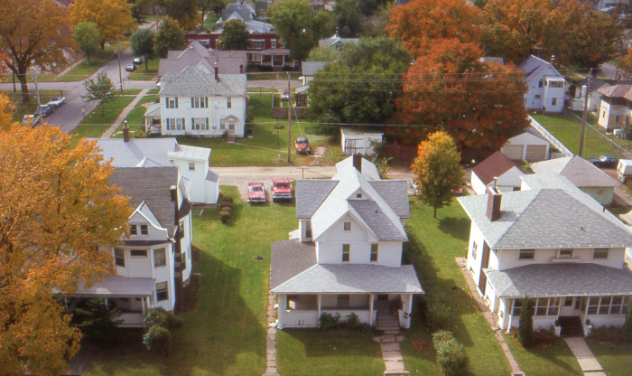 Aerial view of quiet residential neighborhood with autumn trees, representing haunted places in America concept. Aerial view of quiet residential neighborhood with autumn trees, representing haunted places in America concept.