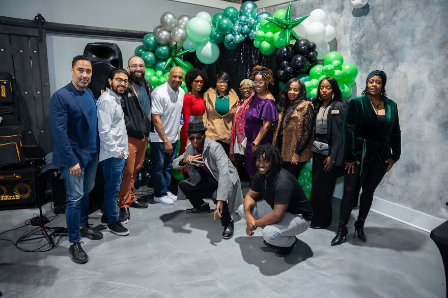 Group of diverse people posing together at an event with balloons, illustrating work-life balance disaster jobs theme.