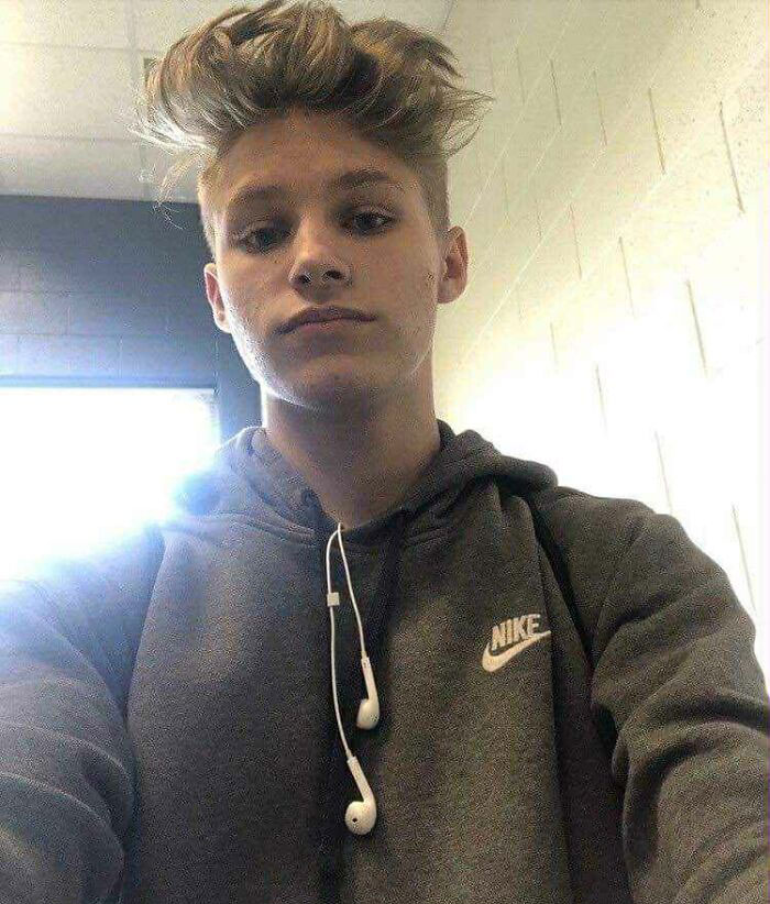 Teenage boy wearing a gray Nike hoodie with earbuds, representing a dad who heard his late son&rsquo;s heartbeat inside a teddy bear.