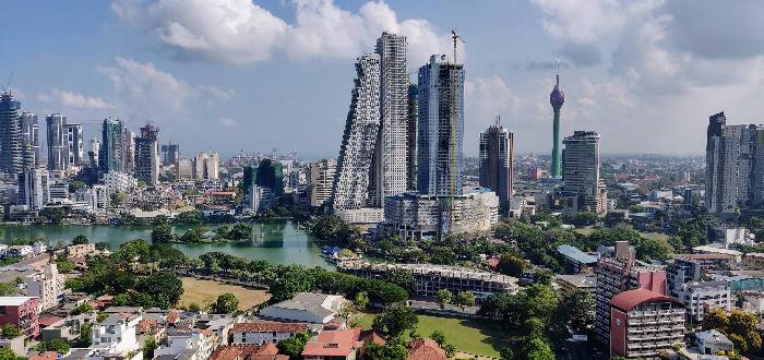 Urban skyline with river, parks and high-rise towers, representing most stressful countries and urban stress.