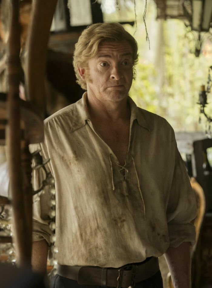 Man in dirty period costume on movie set, depicting a scene shared by movie set workers about diva stars.