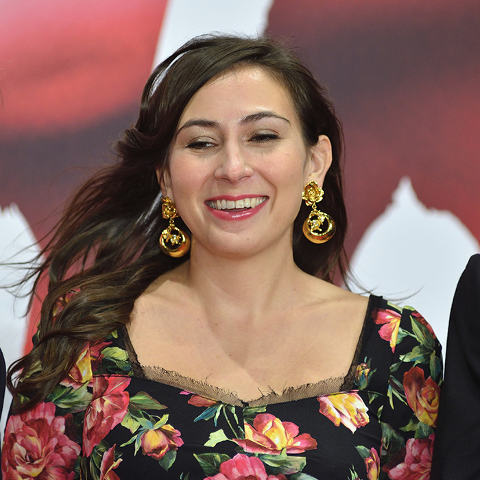 Woman smiling with floral dress and gold earrings, related to new theory after 911 call reveals code word in Victoria Jones case. Woman smiling with floral dress and gold earrings, related to new theory after 911 call reveals code word in Victoria Jones case.