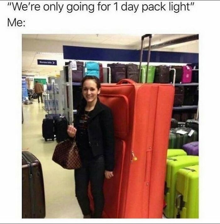 Woman smiling next to an oversized orange suitcase in a luggage store, illustrating hilarious travel memes about packing light.