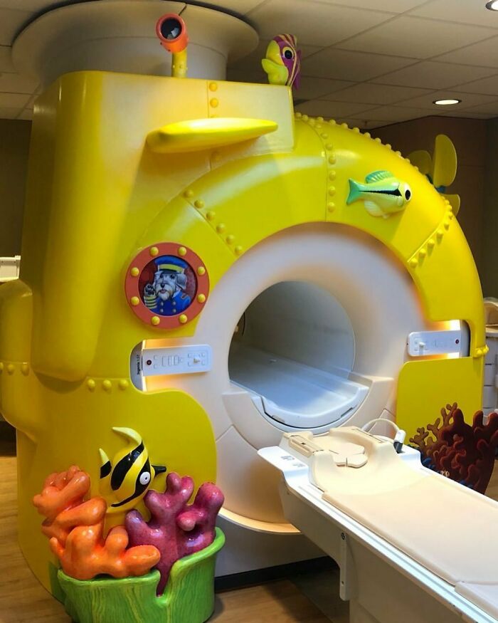Child-friendly MRI machine designed like a yellow submarine with colorful sea-themed decorations to ease medical scan anxiety.